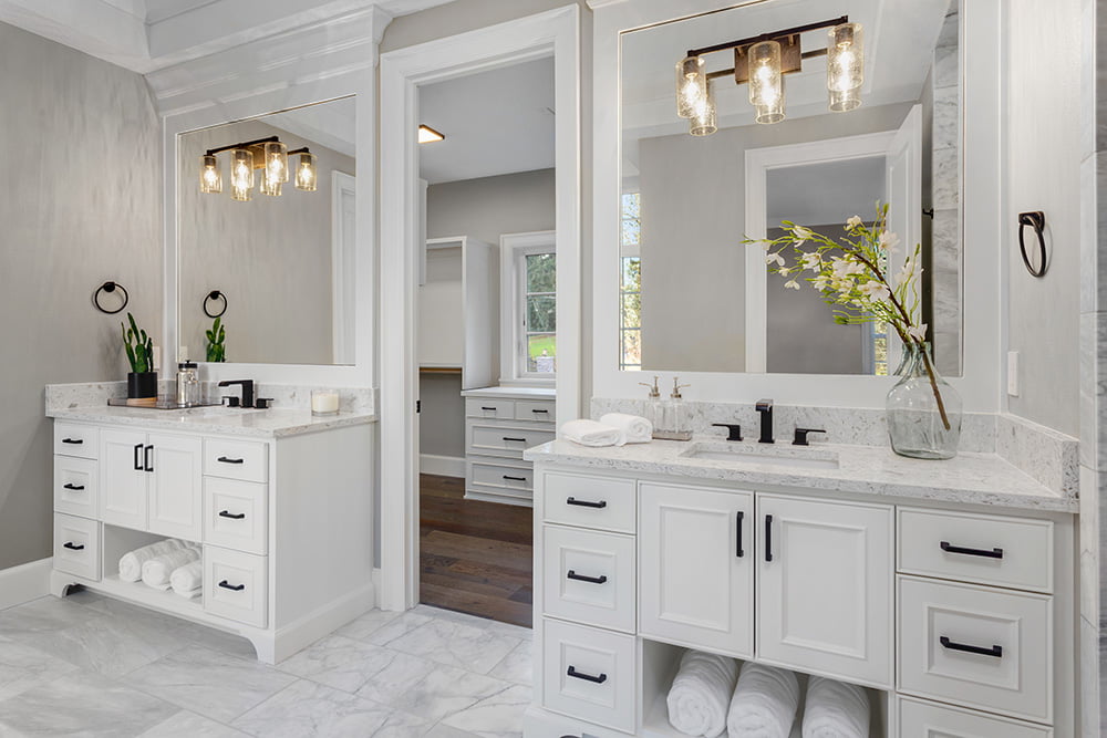 Beautiful bathroom in new luxury home with two vanities, sinks, and mirrors.